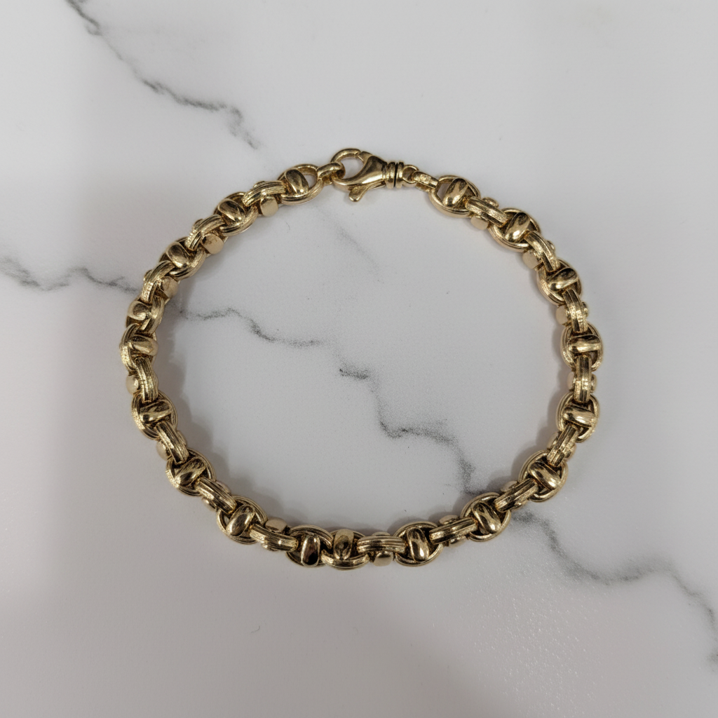 10K Yellow Gold Rope Chain Bracelet on white marble – studio shot
