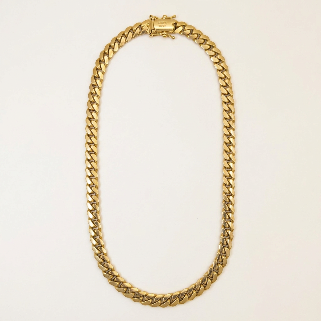 G543 solid 10K yellow gold Miami Cuban link chain in an elongated oval studio view