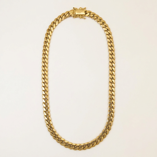 G543 solid 10K yellow gold Miami Cuban link chain in an elongated oval studio view