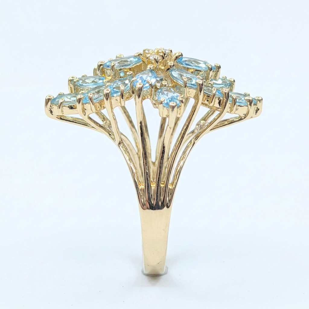 Side profile showing the split-shank gold branches beneath the aquamarine cluster