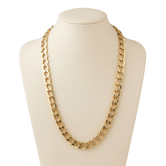 G335 14K yellow gold 5.6mm curb link chain, 22 inches, on a cream bust against white
