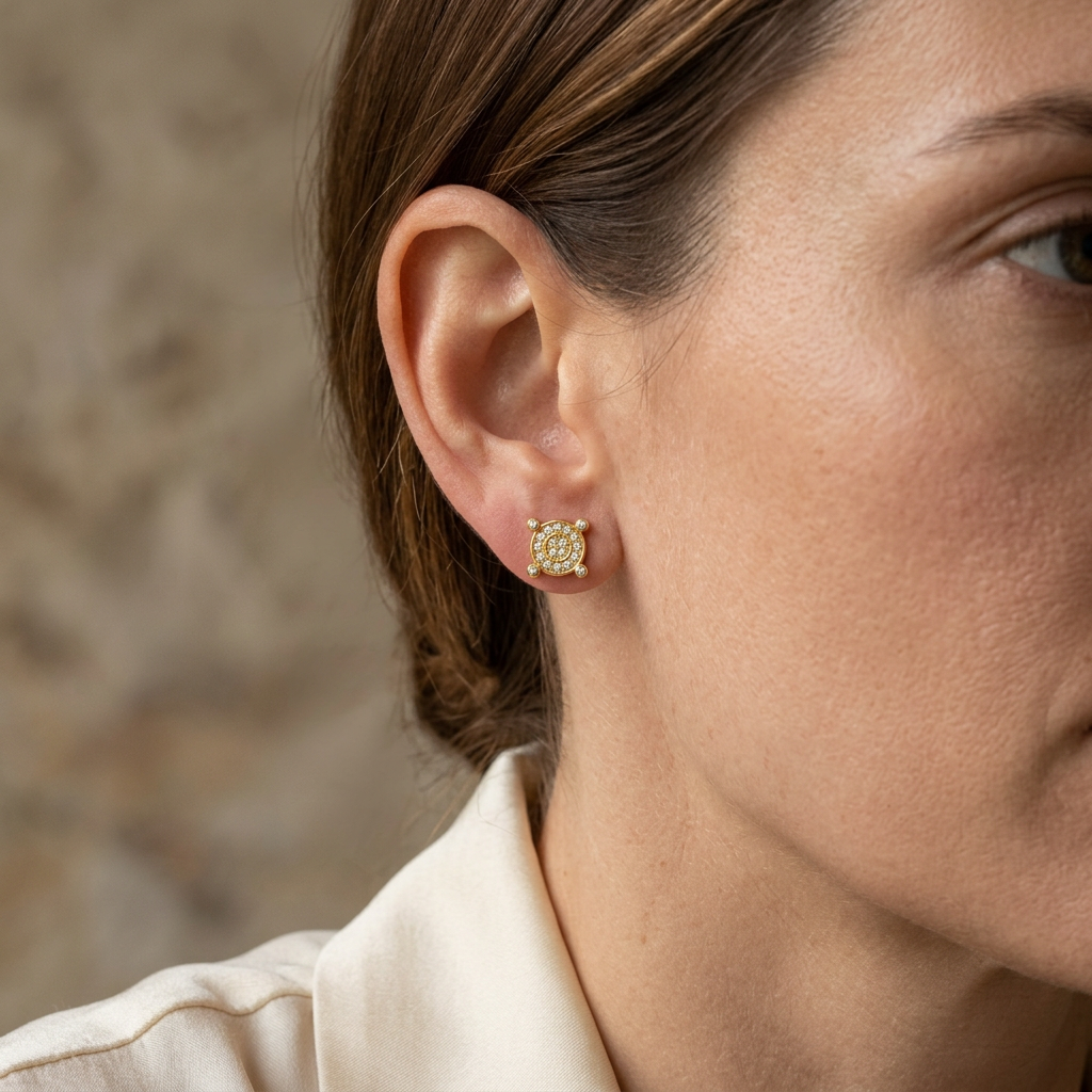 Lifestyle view of a yellow gold diamond compass stud worn on the ear