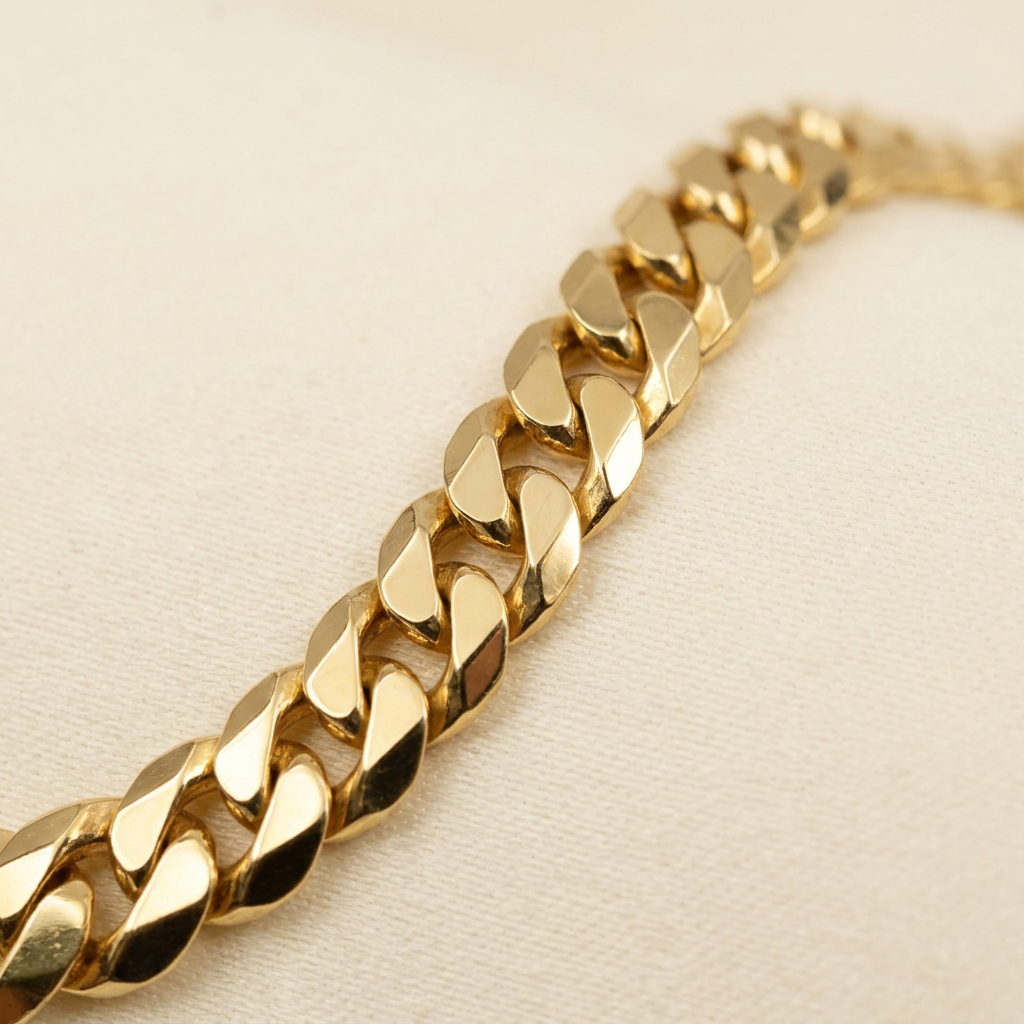 Close-up of polished 14K yellow gold Cuban bracelet links