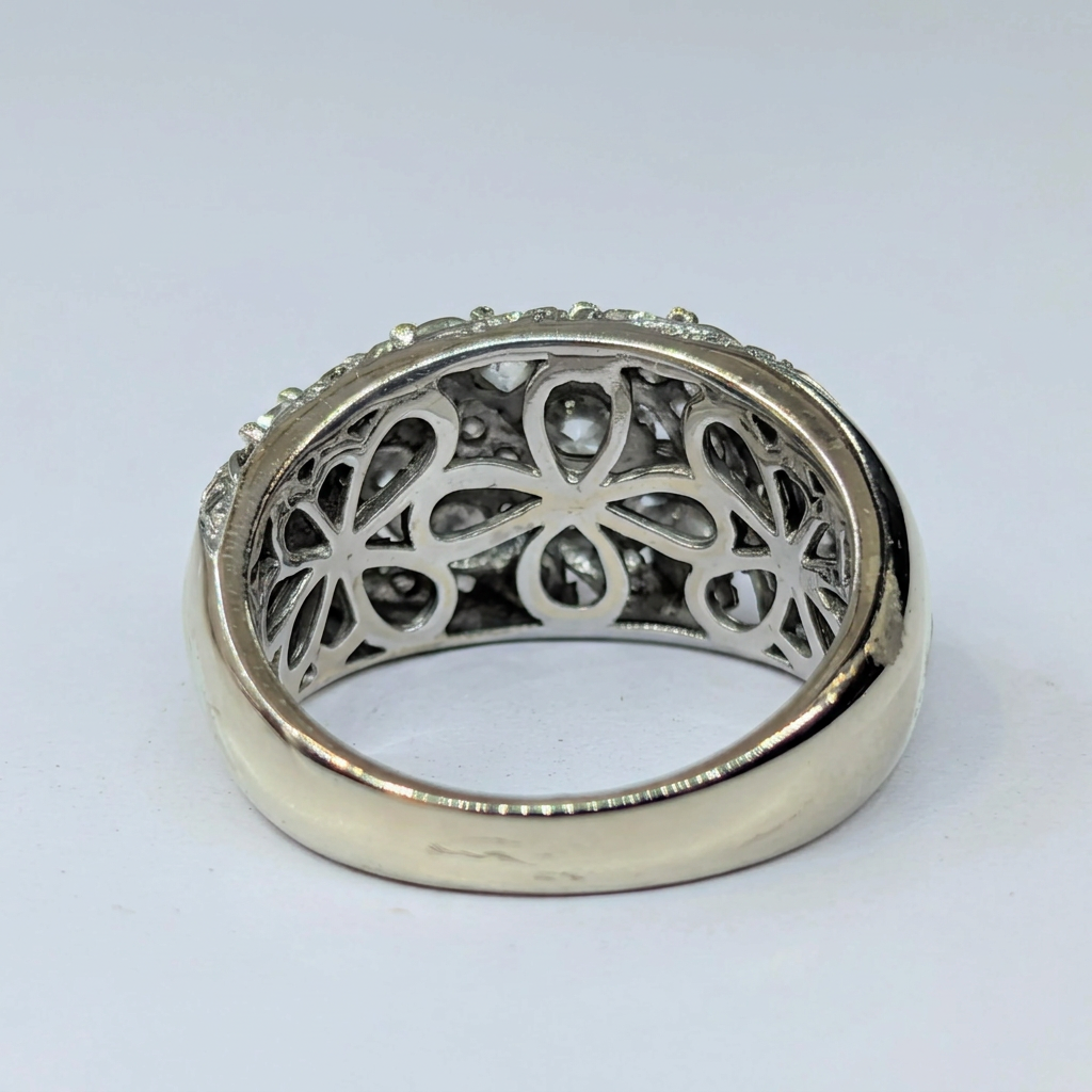 Floral openwork gallery beneath 14K white gold diamond ring