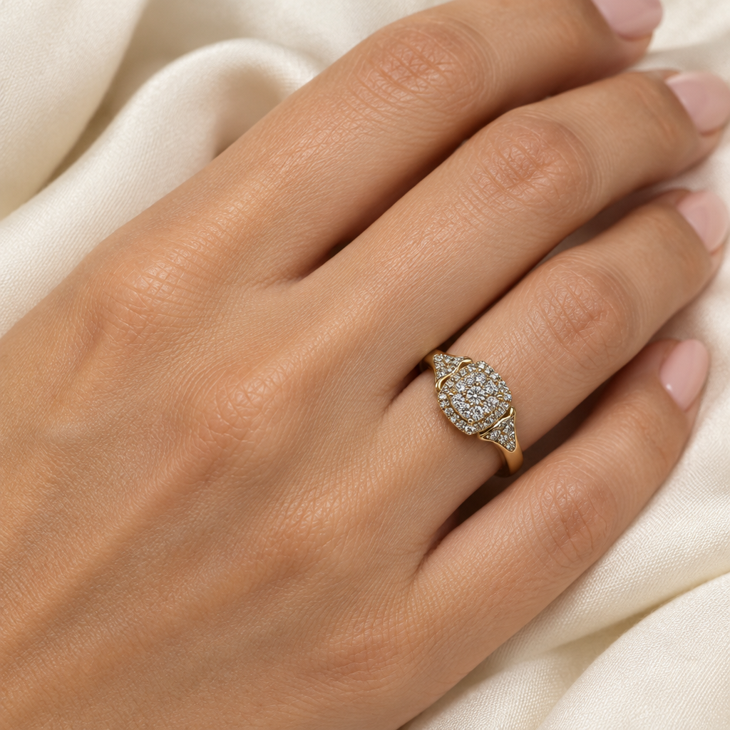 Yellow gold diamond cluster ring worn on a hand