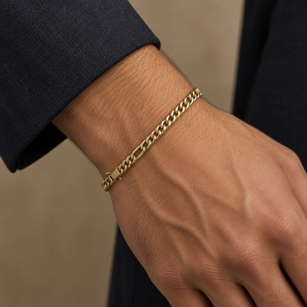Yellow gold Figaro bracelet worn on a wrist