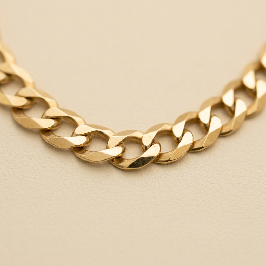 Close-up of polished yellow gold curb links