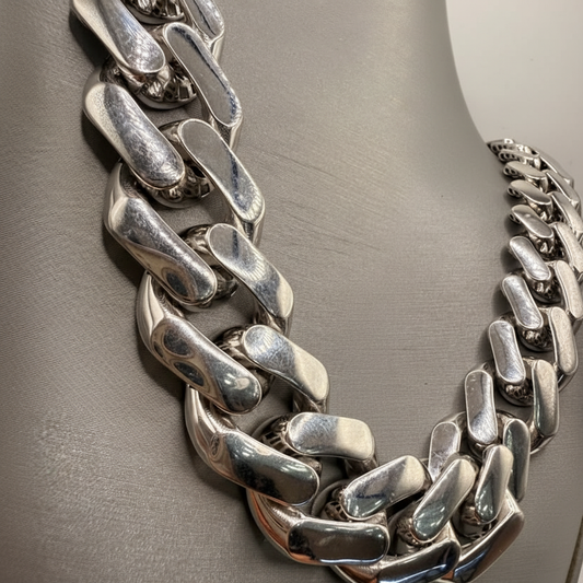 Close-up of polished interlocking links on an 18K white gold Miami Cuban chain