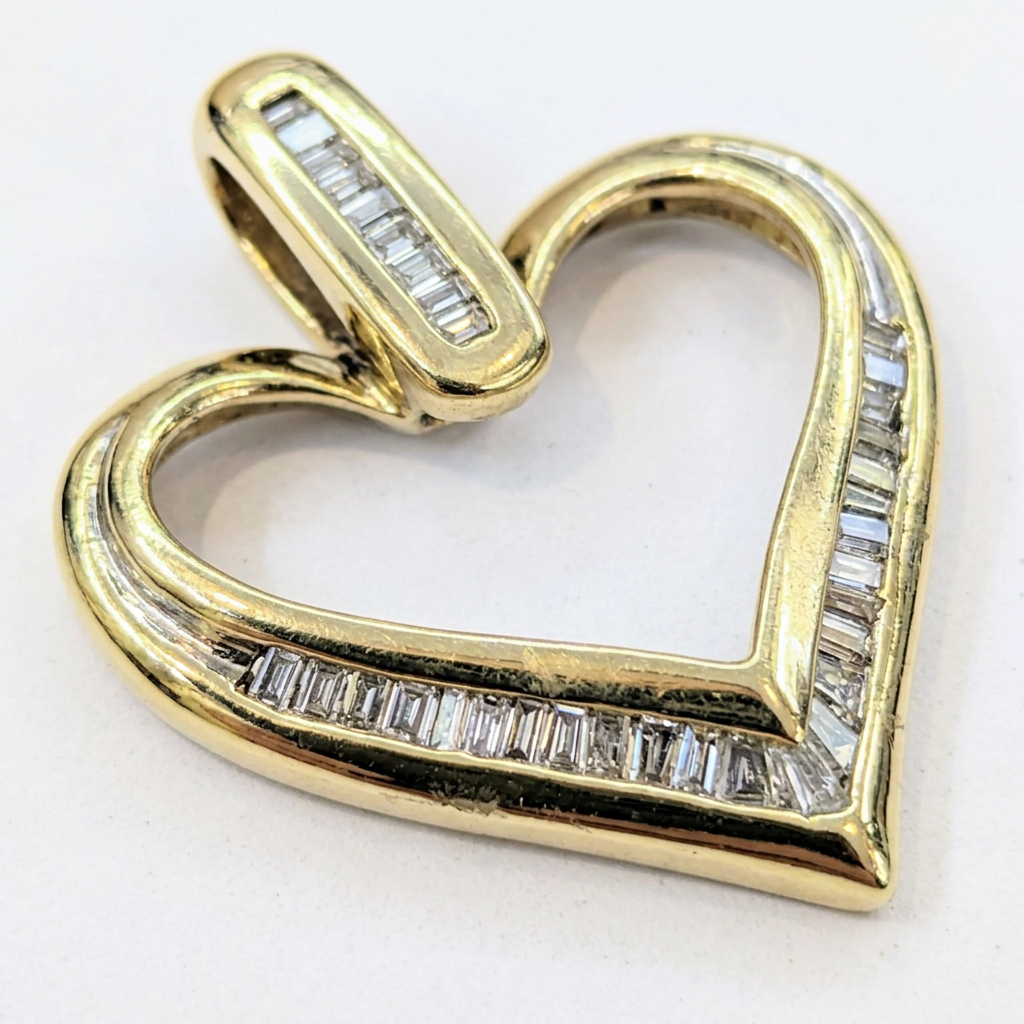 Close-up of diamond channels and polished gold heart pendant