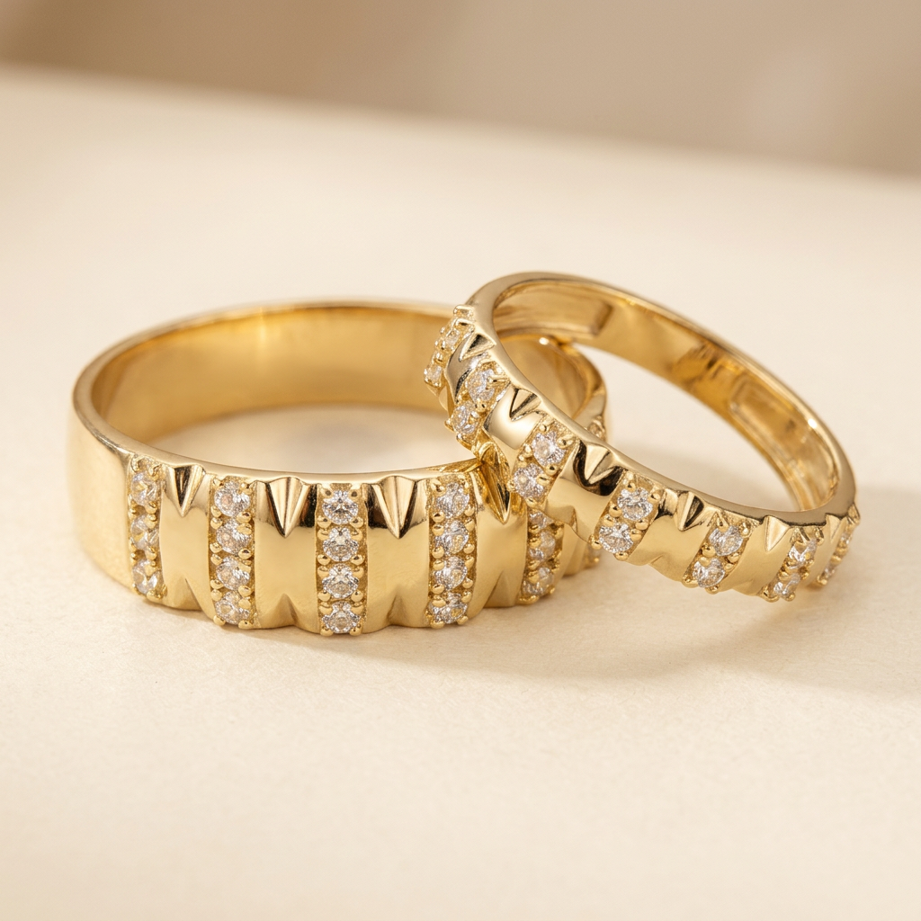 Overlapping yellow gold wedding bands showing coordinating sculpted detailing