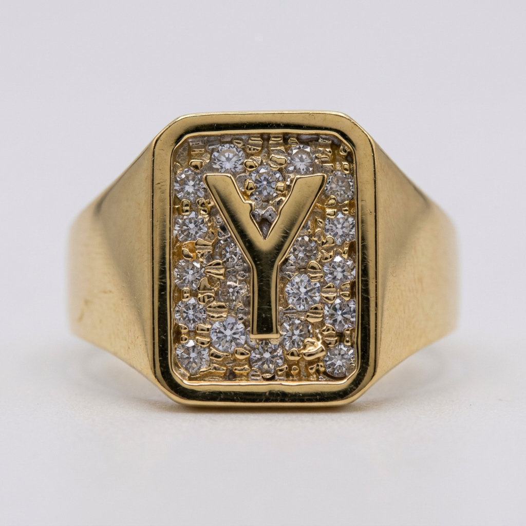 Close-up of gold Y initial and cubic zirconia rectangular ring face
