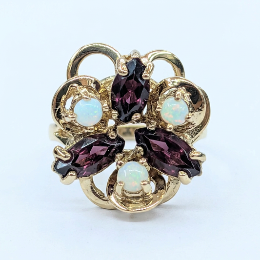 Front view of 10K yellow gold garnet and opal scrollwork ring G115