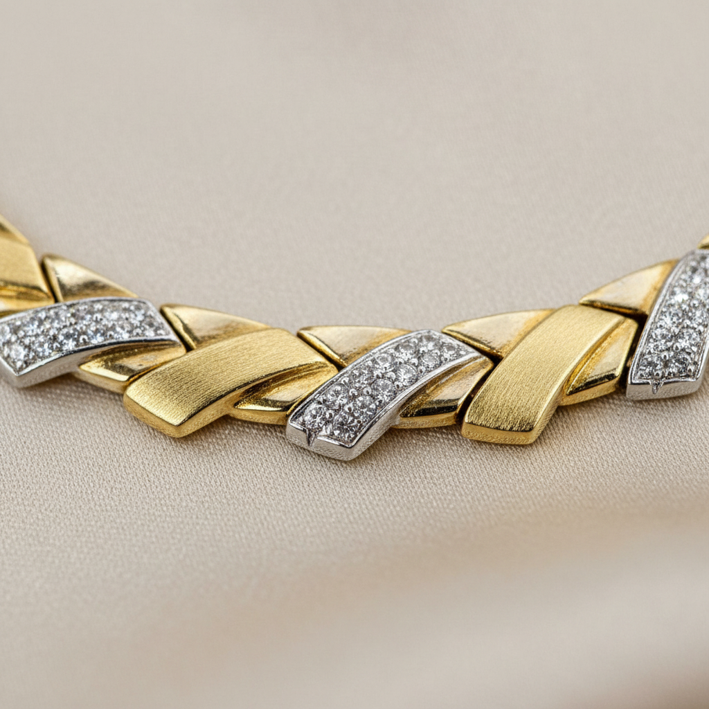 Close-up of alternating yellow gold and crystal-detailed leaf links