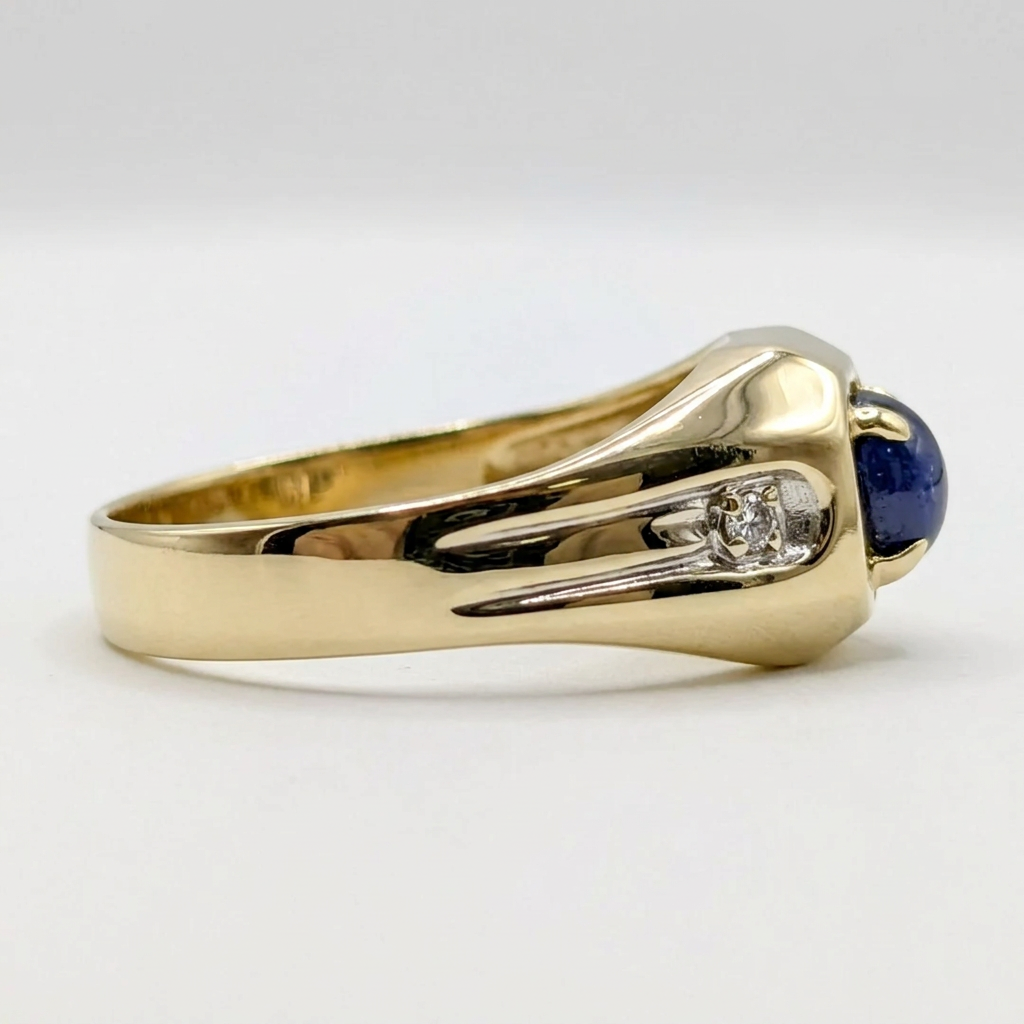 Side profile of the 10K yellow gold ring showing the chiseled white gold shoulder panel, diamond accent, and deep blue sapphire