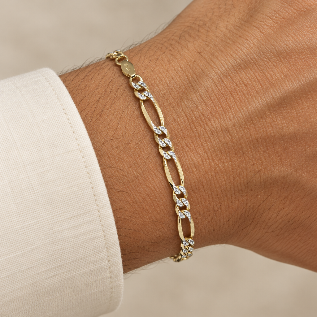 6.7mm yellow gold Figaro bracelet worn on an adult wrist