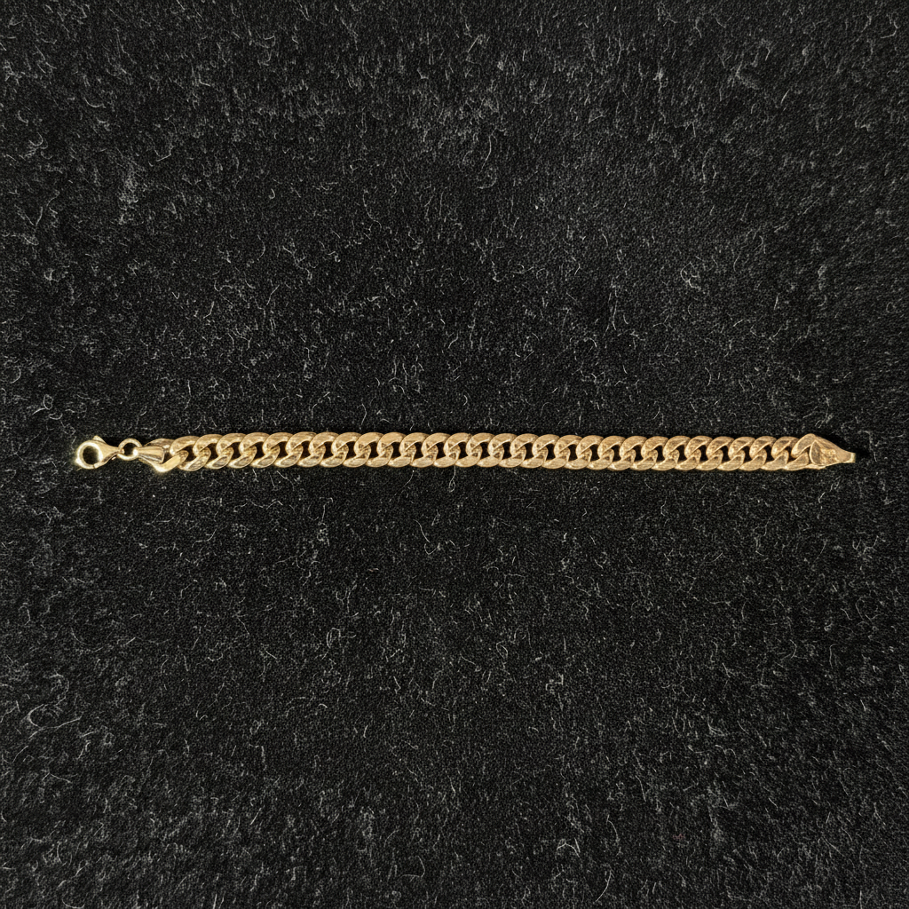 10K Yellow Gold Cuban Link Bracelet angled on black velvet tray