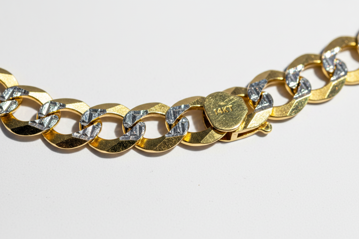 Close-up macro detail of 14K diamond cut curb link bracelet showing yellow and white gold contrast