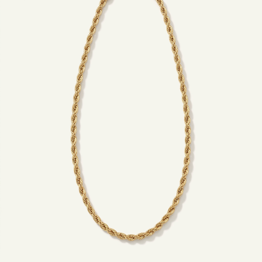 14K yellow gold rope chain necklace in an elongated oval on an ivory background