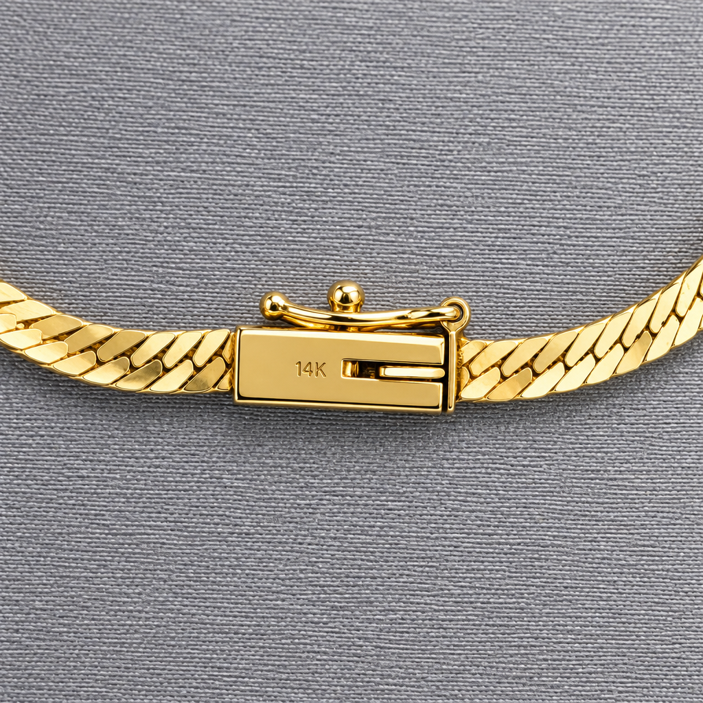 Close-up of the fold-over clasp on the 14K gold herringbone necklace