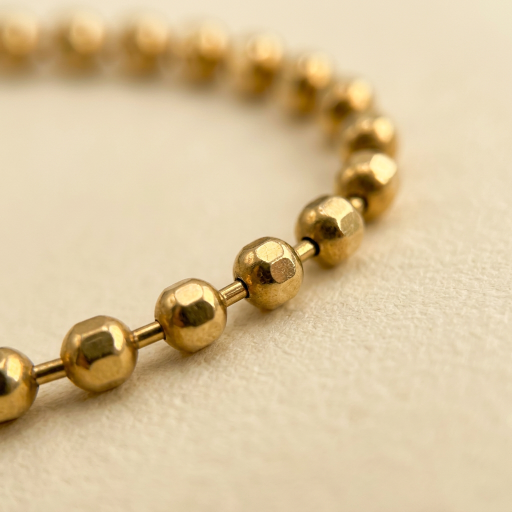 Close-up of faceted yellow gold ball beads and connectors