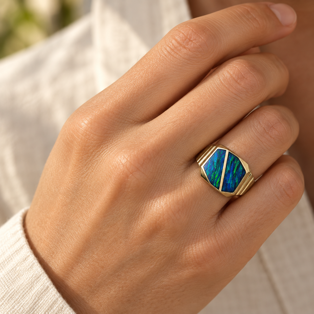 Opal inlay gold ring worn on a hand for scale
