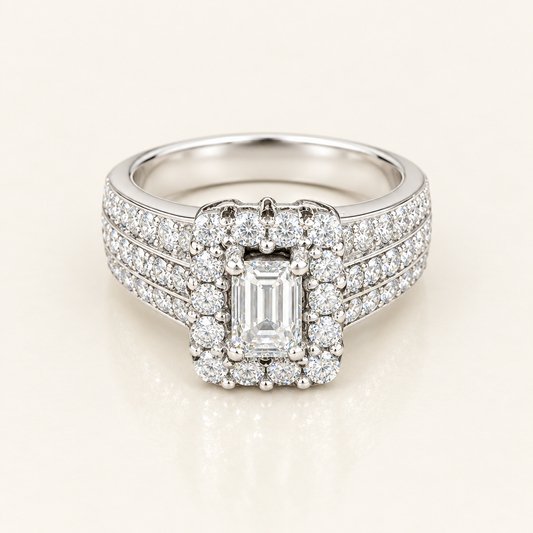 Front three-quarter view of white gold emerald-cut diamond halo engagement ring