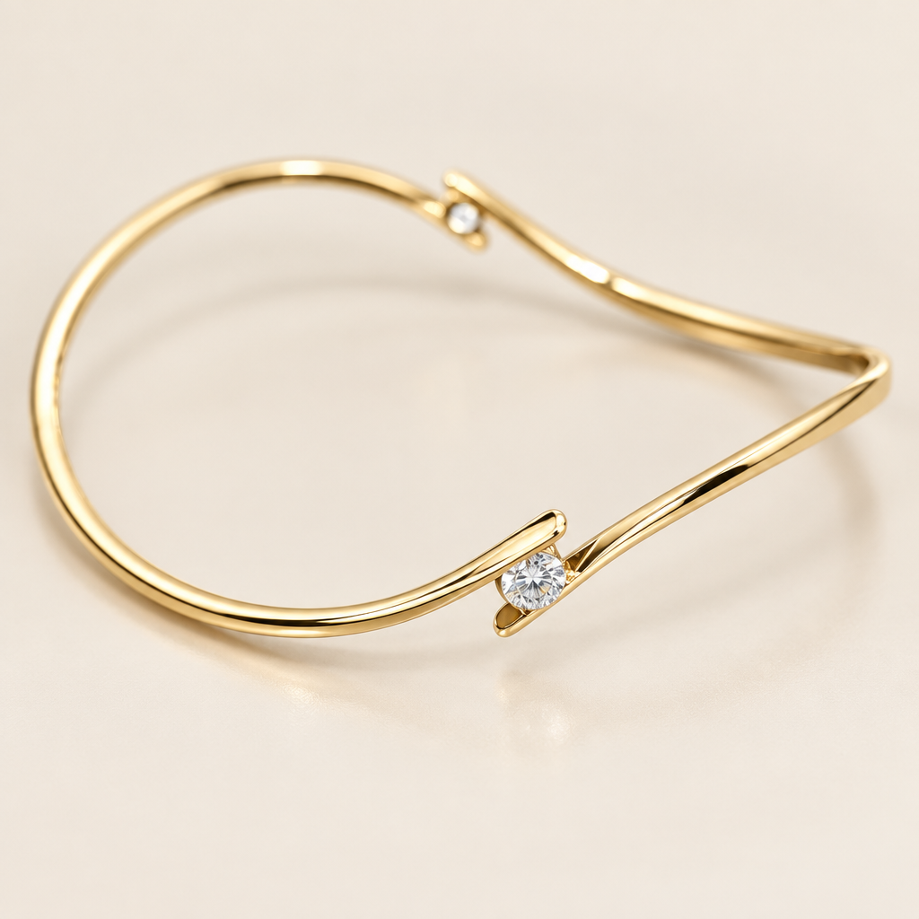 Close-up of the round diamond and polished 14K yellow gold bypass design