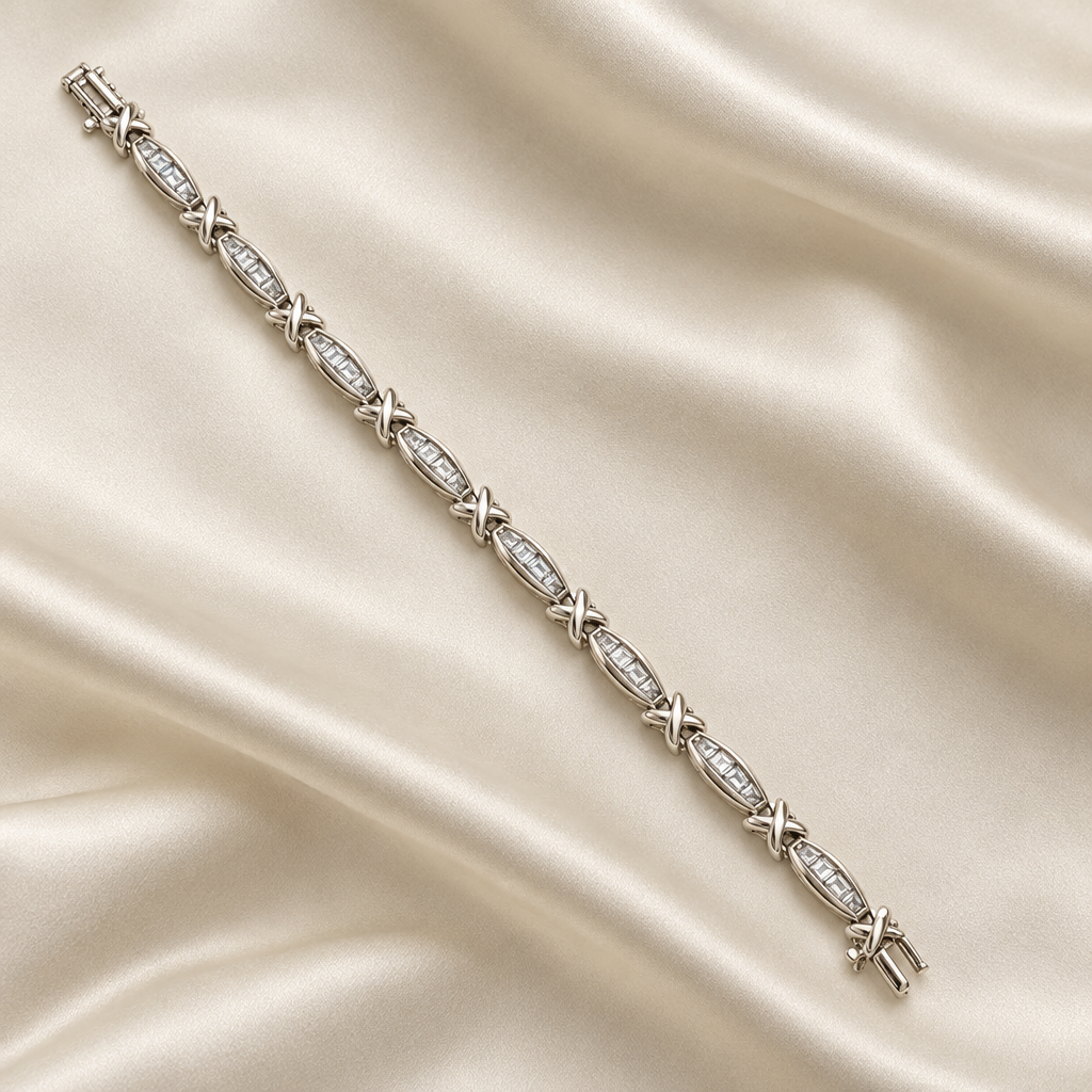 Seven-inch white gold baguette diamond bracelet displayed on ivory silk