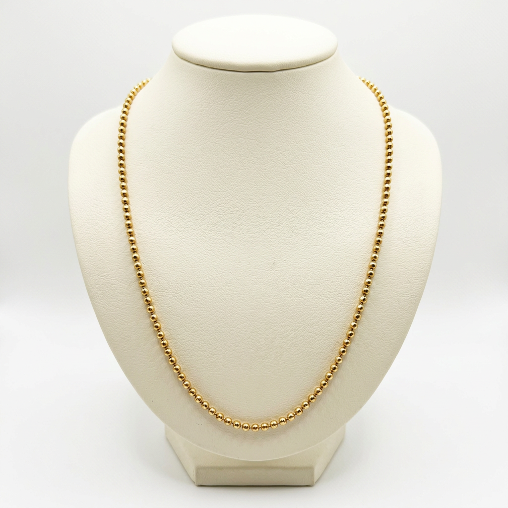 14K yellow gold 2.2mm ball chain necklace displayed on an ivory bust