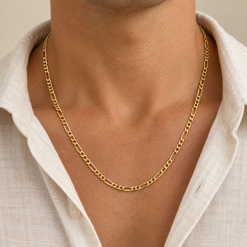 Model wearing a 3.25mm yellow gold Figaro chain with cream linen shirt
