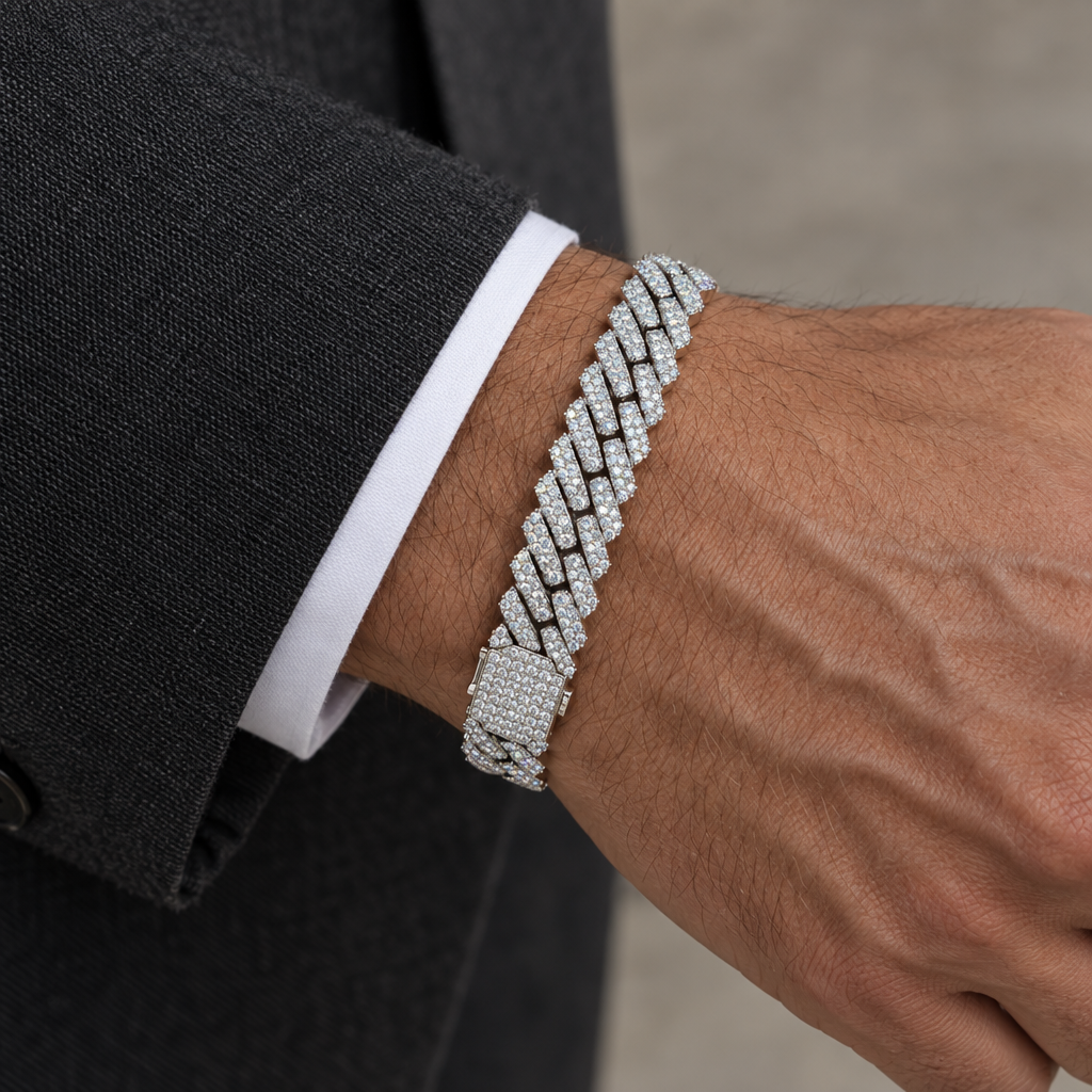 11.5mm white gold diamond bracelet worn on a wrist beside a charcoal tailored sleeve.
