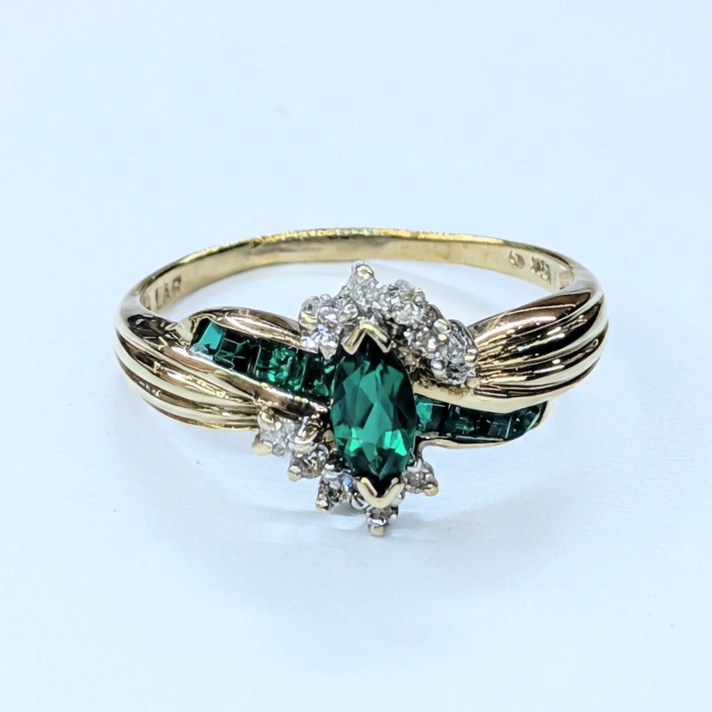 G117 10K yellow gold synthetic emerald and diamond bypass ring, front view