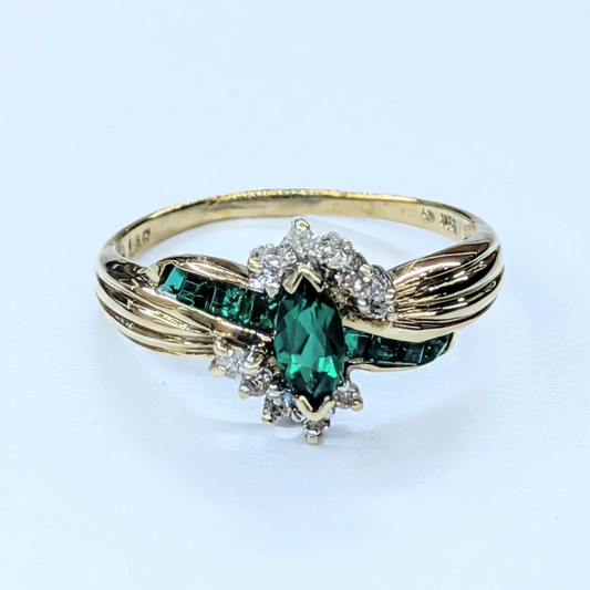 G117 10K yellow gold synthetic emerald and diamond bypass ring, front view