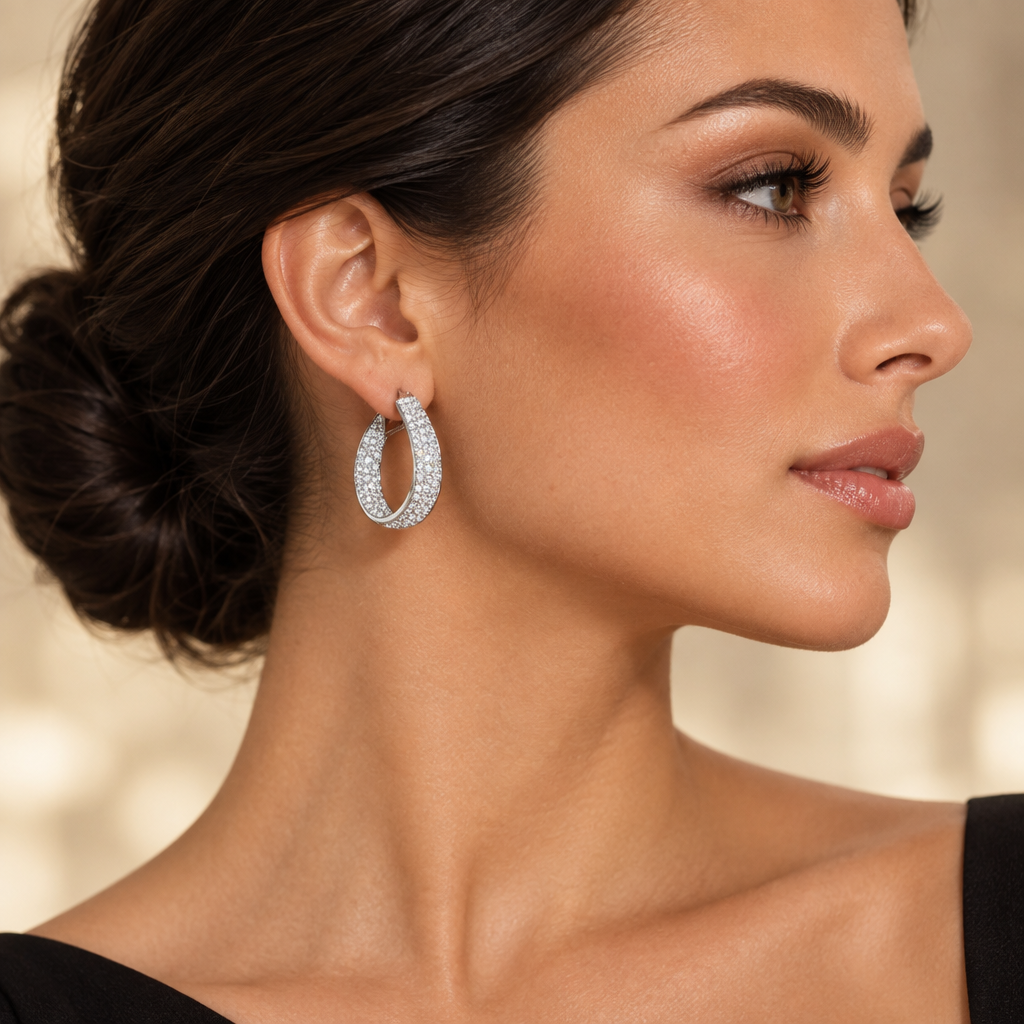 Woman in profile wearing 14K white gold diamond pavé tapered teardrop hoop earrings