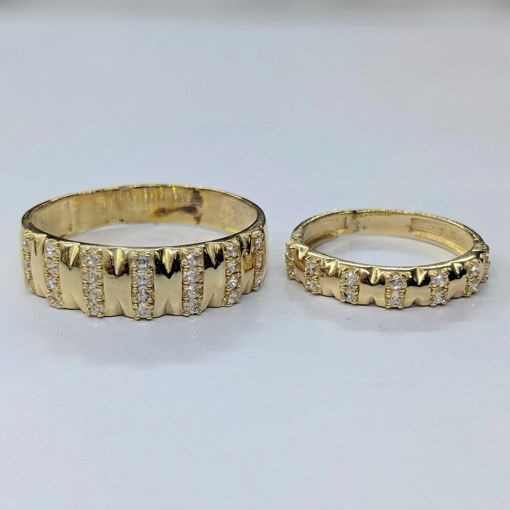 Detail view of the two yellow gold wedding bands and vertical clear stone accents