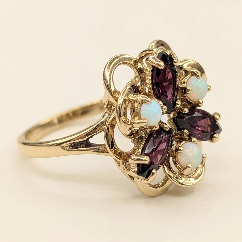 Detail of raised gallery and yellow gold band on garnet and opal ring