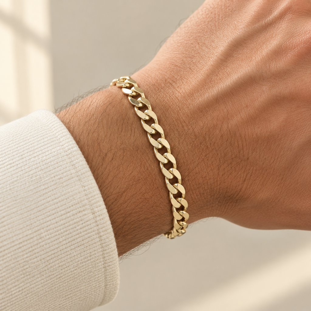7.75mm yellow gold curb bracelet worn on an adult wrist