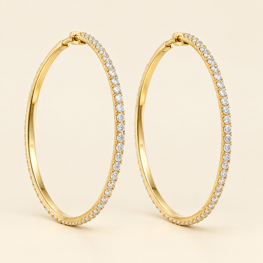 Pair of yellow gold lab-grown diamond hoop earrings on ivory background