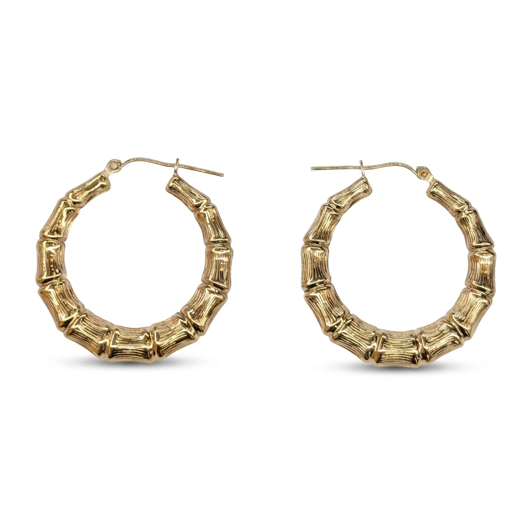 Pair of 10K yellow gold bamboo hoop earrings on white background