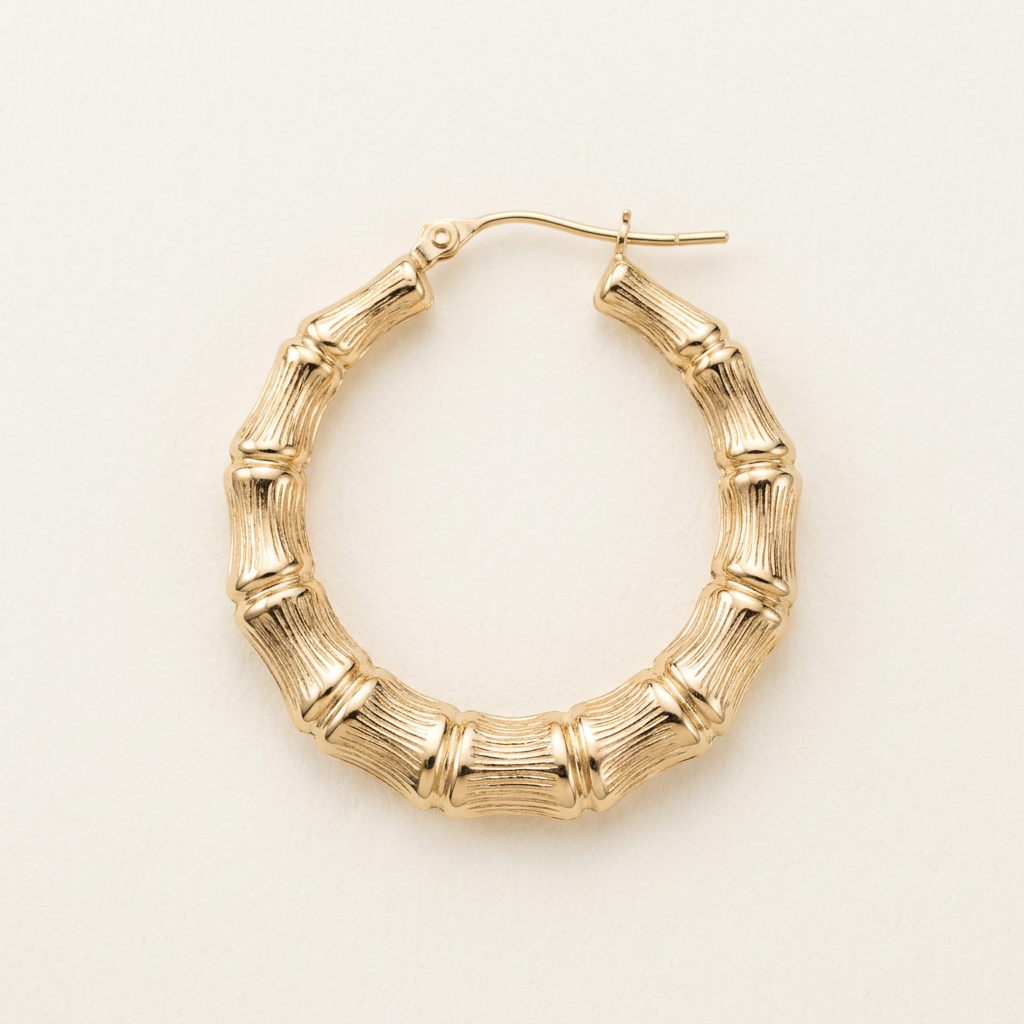 Close-up of textured bamboo detailing on a 10K yellow gold hoop earring